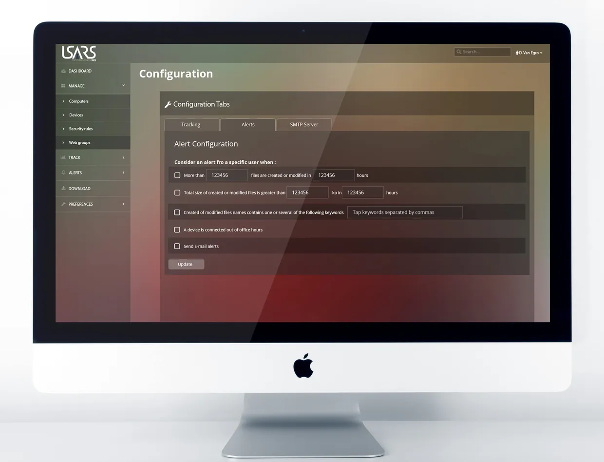 La schermata Configuration di ISARS sullo schermo di un iMac: nel menu laterale Manage è aperto con Computers, Devices, Security rules e Web groups; al centro la scheda Alerts con le condizioni di Alert Configuration e il pulsante Update